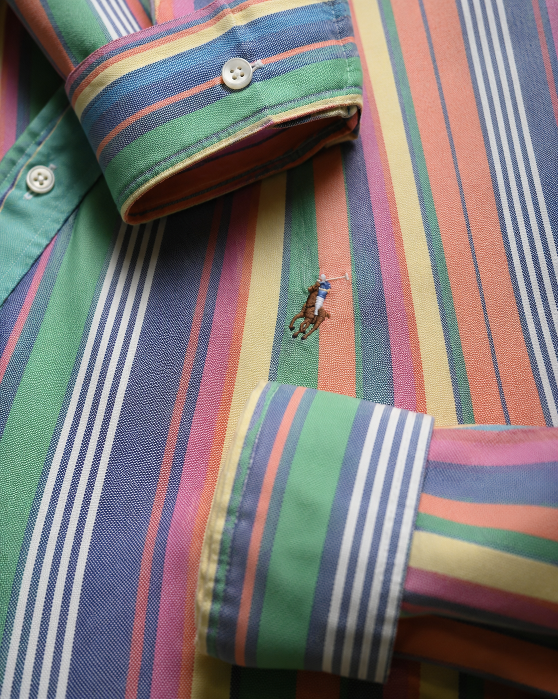 Close-up of a colorful striped shirt with a brand Embroidered Ralph Lauren pony logo