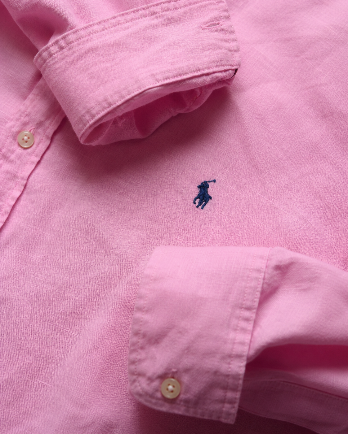 Close-up of a rose hamptons pink shirt with Navy embroidered Ralph Lauren pony logo on pink linen oversized shirt slim fit