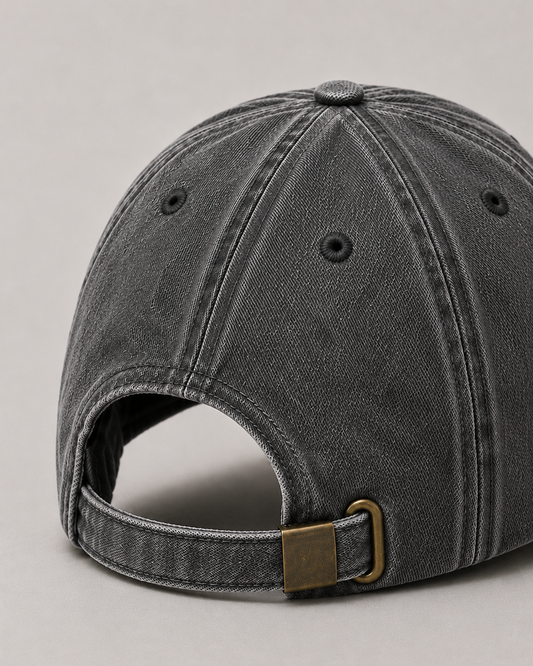 Gray cap with a brown buckle on a light gray background