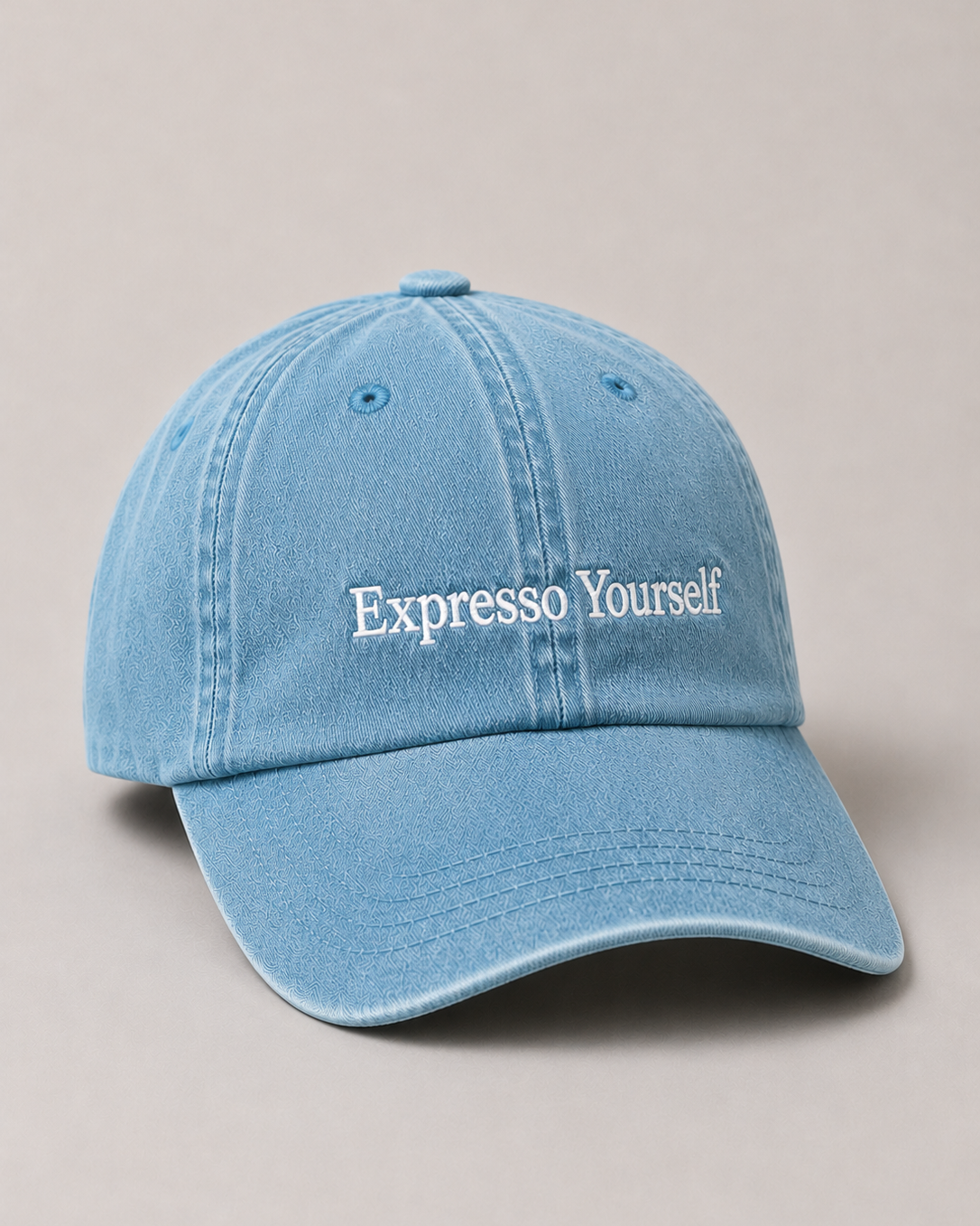 Light blue cap with 'Expresso Yourself' text on a beige background