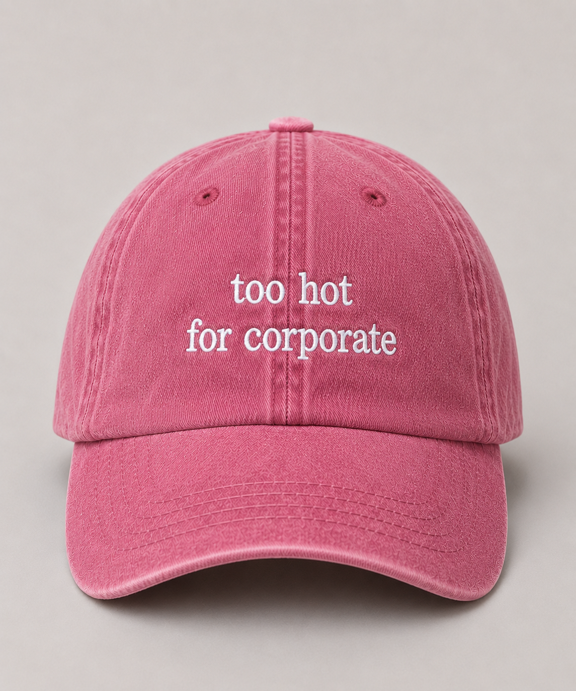 Pink cap with 'too hot for corporate' text on a beige background