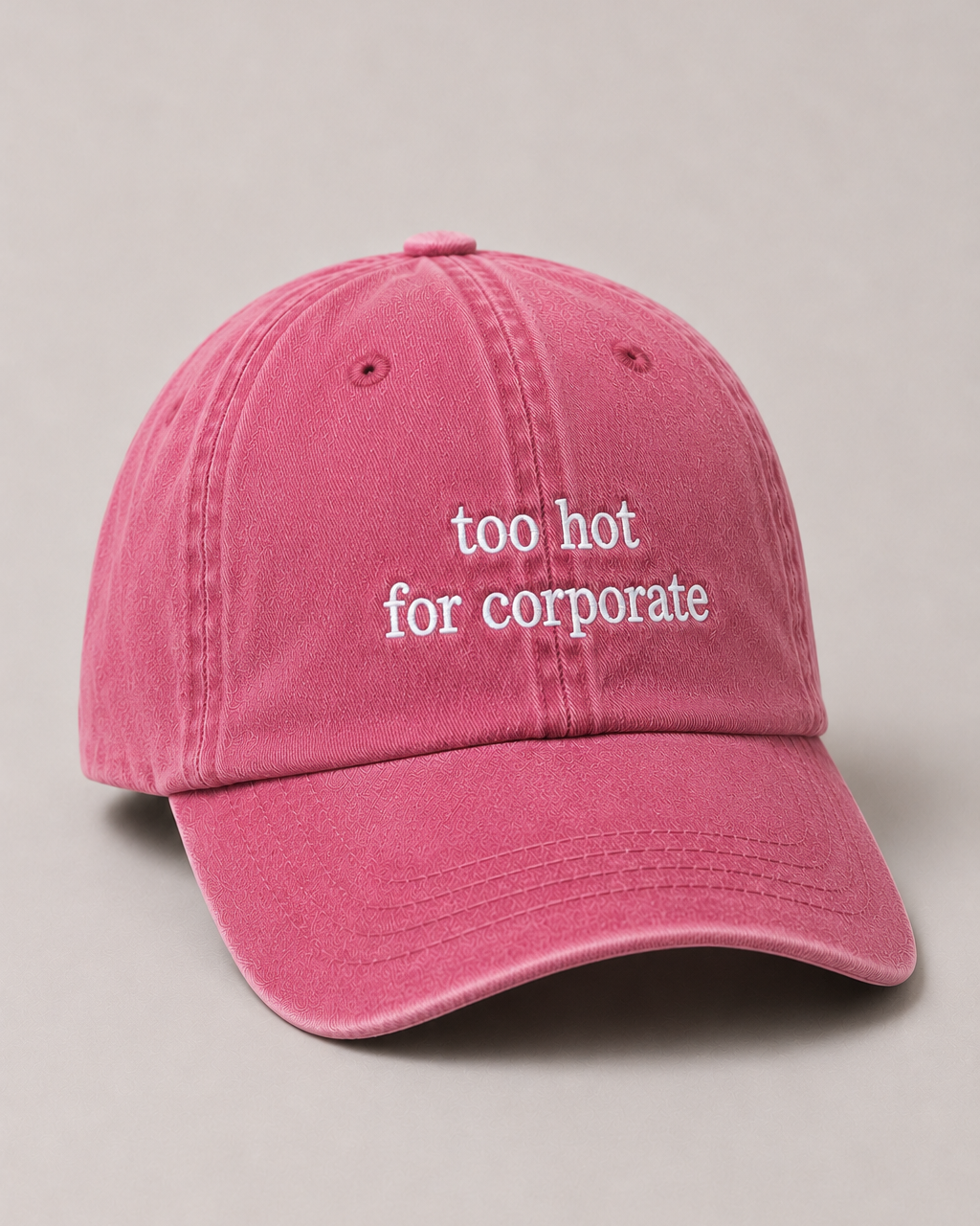 Pink cap with 'too hot for corporate' text on a beige background