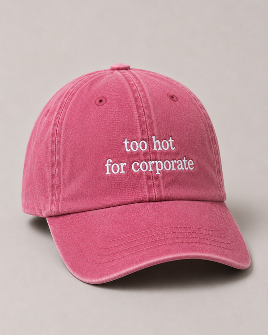 Pink cap with 'too hot for corporate' text on a beige background