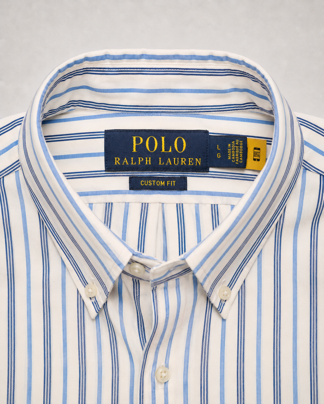 Close-up of a Polo Ralph Lauren custom fit striped navy blue white shirt collar and label detail