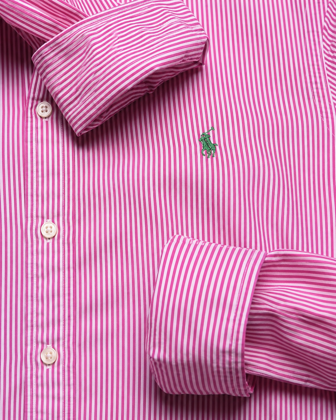Close-up of a green embroidered Polo Ralph Lauren logo on white and pink striped vintage shirt